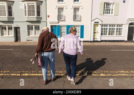 Angleterre, Kent, Deal, Seafront Housing, couple âgé traversant la route Banque D'Images