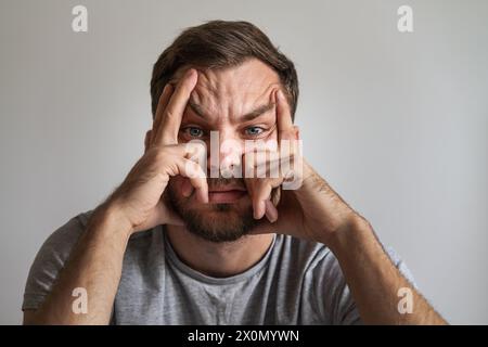 Expression faciale de l'homme déprimé et fatigué. Visage de la mélancolie et de la personne masculine refoulée. Banque D'Images