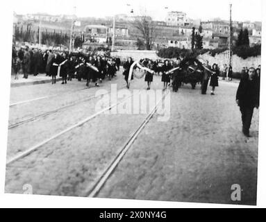 FUNÉRAILLES DES VICTIMES DE LA FUSILLADE DE SERVOLA : TRIESTE - la tête de la procession, portant les deux grandes étoiles rouges de chaque côté de la route, approchant du cimetière. Négatif photographique, Armée britannique Banque D'Images