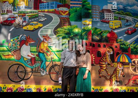 Dhaka, Bangladesh. 14 avril 2024. Un couple pose pour une photo devant un graffiti lors de la célébration du premier jour du nouvel an bengali, à Dhaka. Des milliers de Bangladais célèbrent le premier jour du nouvel an bengali ou Pohela Boishakh, avec différents rassemblements colorés, des programmes culturels avec des danses traditionnelles et de la musique, cette année bengali a été introduite sous le régime de l'empereur Akbar pour faciliter la collecte des revenus au 16ème siècle. Crédit : SOPA images Limited/Alamy Live News Banque D'Images