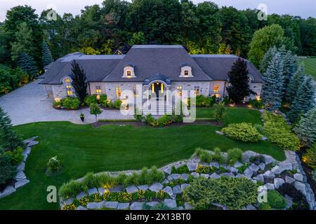 Découvrez l'attrait des maisons de luxe à des millions de dollars dans des paysages crépusculaires captivants. Explorez les superbes jardins et jardins sous la nuit Banque D'Images