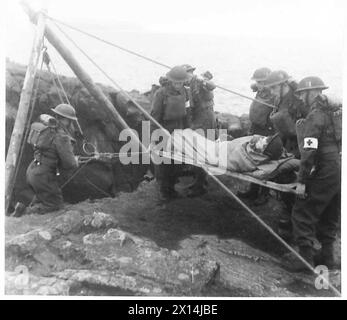 NOUVELLE MÉTHODE DE SAUVETAGE DES VICTIMES DES FALAISES - montage de l'appareil au sommet de la falaise avant la démonstration. Un patient sur civière étant rendu rapide à l'appareil pour descendre la falaise face à l'armée britannique Banque D'Images