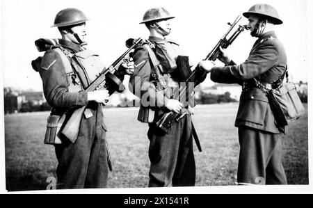 Deux jeunes soldats des bataillons de l'armée britannique sont vus armés d'un canon Tommy et d'un canon Bren pendant l'entraînement ou le déploiement. Banque D'Images