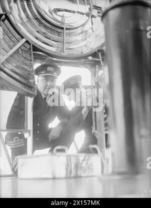Le HMT Stella Pegasi escorte le navire Pole Star en juillet 1943 tout en débarquant des magasins et des fournitures pour les équipages du phare autour de la côte, le gardien du phare du cap Wrath montrant la lumière au capitaine. Banque D'Images
