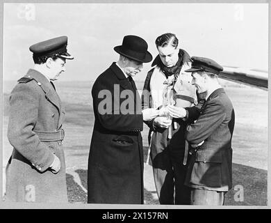 SIR JOHN COLVILLE : GOUVERNEUR DE BOMBAY DÉSIGNÉ : VISITE L'ESCADRON DE COMMANDEMENT DE CHASSE DE BOMBAY. - John Colville, gouverneur désigné de Bombay en visite à l'escadron de Bombay du commandement des chasseurs. (Photo publiée en 1943) Un obus de canon de 20 mm est montré à Sir John Colville par l'un des pilotes. Sur la gauche se trouve le commandant de la station, le capitaine G. Adnams, et le chef d'escadron D.E. Kingaby, DFM & 2 bars, C.O. de l'escadron de Bombay [à droite] Royal Air Force Banque D'Images