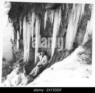 CINQUIÈME ARMÉE : DIVERS - Sapeur Raymond Vass, 525 Field Sqn. R.E., du 7 Glebe Road, Crondall, près de Farnham, Surrey, fait des pauses pour le déjeuner pendant les travaux sur un traversier traversant la rivière Santerno. Un froid amer avait produit ces énormes glaçons. SPR Vass porte une combinaison de neige tout en travaillant, comme la zone ia sous observation ennemie de l'armée britannique Tosignano Banque D'Images