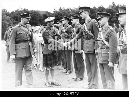 LE ROI ET LA REINE INSPECTENT LE CORPS FORESTIER CANADIEN - sa Majesté serrant la main aux officiers de l'Armée britannique Banque D'Images