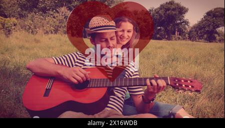 Image de coeur rouge sur couple amoureux de la guitare Banque D'Images