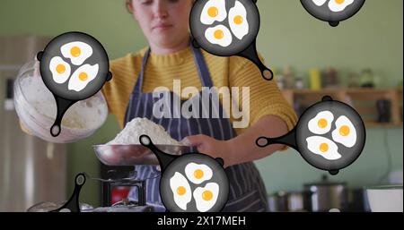 Image d'icônes d'oeufs sur une femme caucasienne en train de cuisiner Banque D'Images