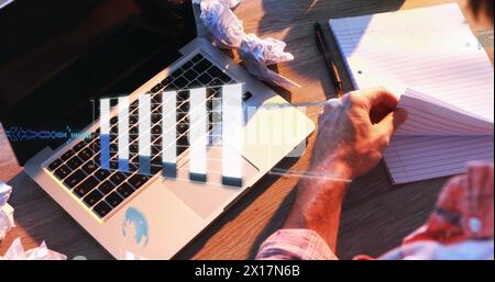 Image de graphiques, langage informatique et globes, vue aérienne de l'homme biracial travaillant sur ordinateur portable Banque D'Images