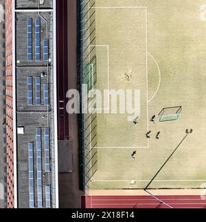 Une photo aérienne montre des joueurs de football sur un terrain de football, à côté d'eux des panneaux solaires sur le toit d'un bâtiment, Berlin, Berlin, Allemagne Banque D'Images