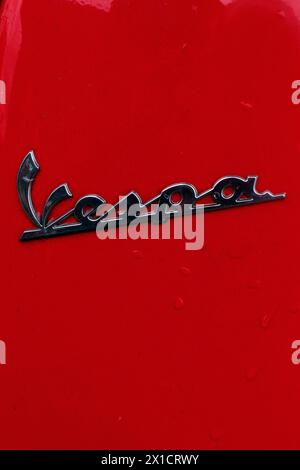 Badge scooter Vespa sur peinture rouge, Gênes, Italie Banque D'Images