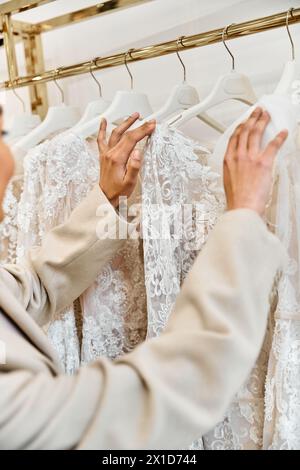 Une jeune mariée belle essaie une superbe robe de mariée blanche dans une boutique. Banque D'Images