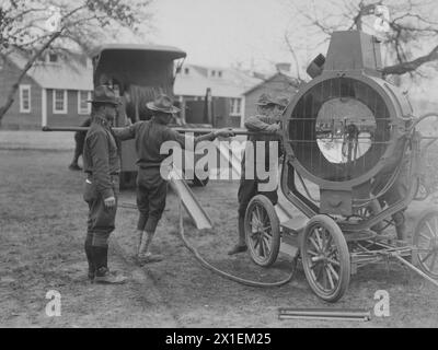 Un soldat insère une poignée de commande de tuyau dans un projecteur antiaérien mobile à Washington Barracks D.C. CA. 1918 Banque D'Images