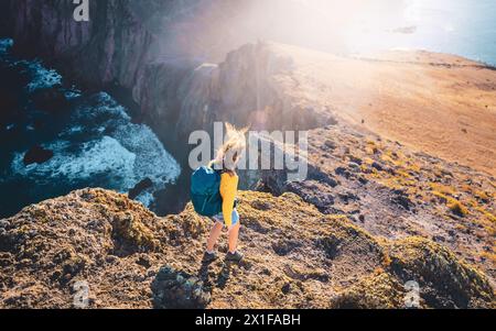 Description : vue d'angle de dessus d'une femme routard marchant vers le bas des contreforts venteux d'une île dans l'océan Atlantique. São Lourenço, île de Madère Banque D'Images