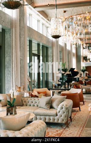 Des canapés avec tables se dressent dans le hall de l'hôtel avec fenêtres panoramiques Banque D'Images