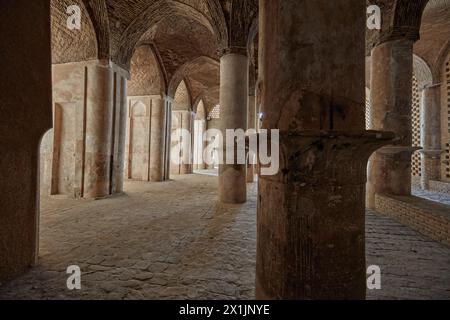 Vue intérieure de la salle hypostyle avec de nombreux piliers soutenant le toit de voûtes en briques dans la mosquée Jameh d'Ispahan, Iran. Banque D'Images