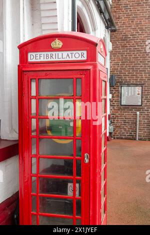 Ancien coffret téléphonique rouge transformé en poste de défibrillation Banque D'Images