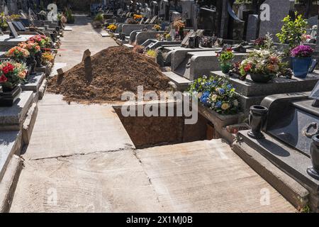 Une tombe fraîchement creusée dans le cimetière. Préparation funéraire. Ouvrez la tombe dans le cimetière. Banque D'Images