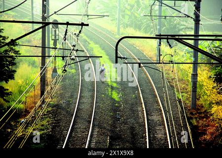 marchant seul le long du chemin de fer vide Banque D'Images