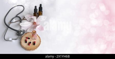 capsules, stéthoscope médical, création d'un nouveau médicament à partir de plantes, cadeaux de la nature, compléments alimentaires, fleurs de magnolia, science du concept, génétique e Banque D'Images