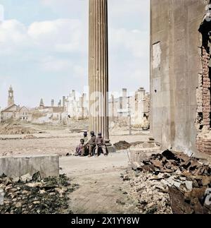 Charleston, S.C. vue des bâtiments en ruine à travers le porche de l'église circulaire (150 Meeting Street). Avril 1865. Photographe : George N. Barnard. Sky est remplacé dans cette version. Quatre enfants afro-américains sont assis à la base d'une grande colonne grecque. Photographies de la marine fédérale et des expéditions maritimes contre la côte atlantique de la Confédération -- plus précisément de Charleston, S.C. 1863-1865. Le succès du général Gillmore au fort Pulaski lui vaut la conduite d'une entreprise beaucoup plus difficile : la réduction des défenses du port de Charleston, avec l'aide d'un escadron sous le commandement du contre-ADM. Banque D'Images