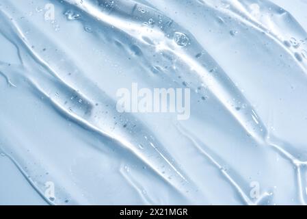 Texture de gel cosmétique transparente gros plan. Sérum de visage acide, fond de gel désinfectant. Gel cosmétique transparent avec bulles d'oxygène. Banque D'Images