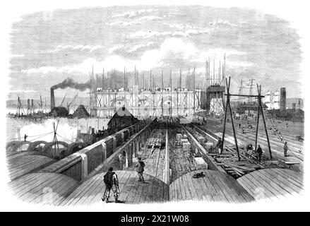 The Metropolitan main-drainage Works at Crossness, [Bexley], 1864. Vue de '...les travaux à cet important débouché pour l'ensemble des eaux usées drainées de la zone sur le côté sud de la Tamise. Le grand bâtiment dans le centre... aura une bonne apparence de la rivière. Il a des prétentions architecturales considérables... le bloc de bâtiments... contient les moteurs, les chaudières, et d'autres machines reliées au grand établissement de pompage... les nombreuses lignes de murs, certaines arquées, au premier plan... sont les œuvres du grand réservoir, dans lequel les eaux usées sont accumulées pendant le Banque D'Images