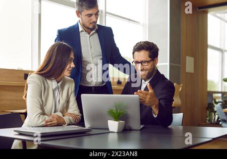 Les gens d'affaires parlent de groupe diversifié à l'ordinateur portable, la culture de coaching pour construire une équipe d'affaires gagnante Banque D'Images