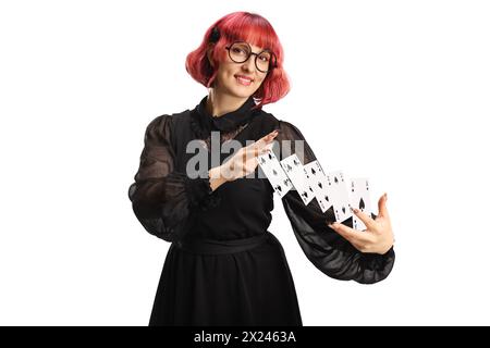 Magicien féminin effectuant un tour avec des cartes isolées sur fond blanc Banque D'Images