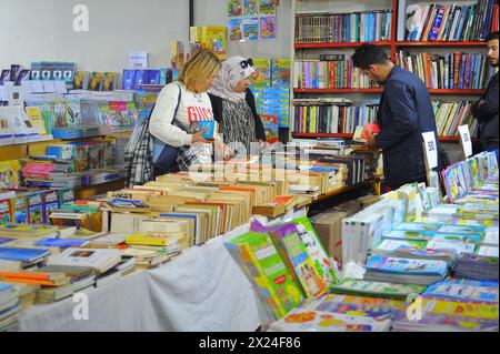 Tunis, Tunisie. 19 avril 2024. Les gens choisissent des livres à la Foire internationale du livre de Tunis, Tunisie, le 19 avril 2024. La 38ème édition de la Foire internationale du livre de Tunis a débuté vendredi au Parc des expositions du Kram à Tunis. Crédit : Adel Ezzine/Xinhua/Alamy Live News Banque D'Images