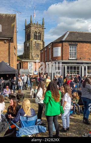 Fêtards et festivaliers appréciant le soleil de printemps sur la place du marché pavée de la ville de Sandbach dans le Cheshire au festival de musique Banque D'Images