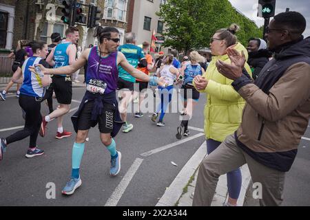 Londres, Royaume-Uni. 21 avril 2024. Courir tout le marathon à l'envers. Le marathon de Londres passe par Evelyn Street à Deptford dans le sud-est de Londres, la marque de 8 miles du parcours de 26,2 miles où les coureurs sont accueillis et encouragés par les résidents locaux. Crédit : Guy Corbishley/Alamy Live News Banque D'Images