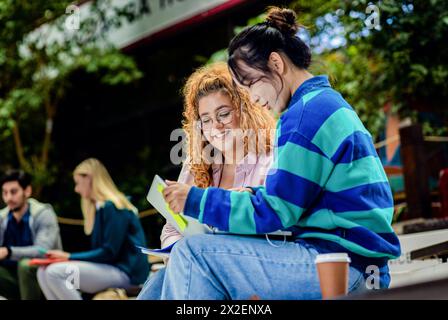 Groupe diversifié d'étudiants se trouvant dans l'apprentissage du campus ensemble. Banque D'Images