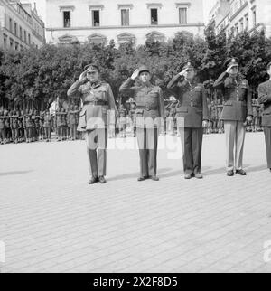 Les généraux Wilson, Devers et André saluent pendant l'hymne national lors d'une cérémonie d'investiture pour les officiers britanniques, français, polonais et américains à Alger le 28 mars 1944. Banque D'Images