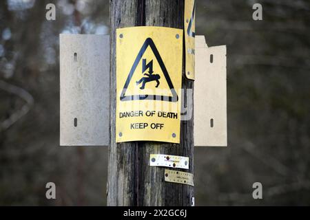 ÉLECTRICITÉ DANGER DE MORT PANNEAU D'AVERTISSEMENT SUR LE POTEAU RE PÊCHEURS ENFANTS AVERTISSEMENTS CANNES À PÊCHE COULER AVEC ATTENTION PANNEAUX ETC UK Banque D'Images