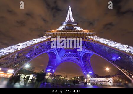 PARIS - DÉCEMBRE 29 : Tour Eiffel illuminée la nuit sur fond de ciel nuageux, vue d'en bas, 29 décembre 2009, Paris, France. C'est th Banque D'Images