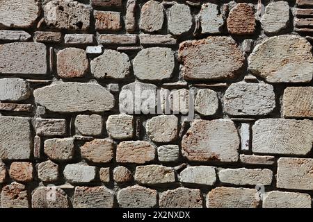 Un mur fait de pierres en gravats. Détail de mur de pierre pour les arrière-plans. Banque D'Images