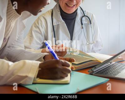 Jeune femme africaine médecin apprenant d'une femme médecin expérimentée. Banque D'Images