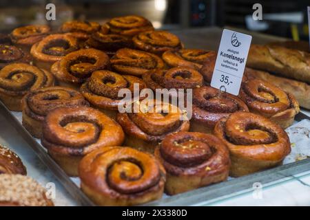 Rouleaux danois à la cannelle (kanelsnegl) dans une vitrine de boulangerie. Banque D'Images