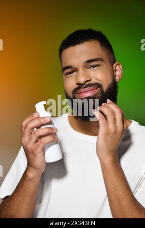 Homme barbu afro-américain tient la crème à raser. Banque D'Images