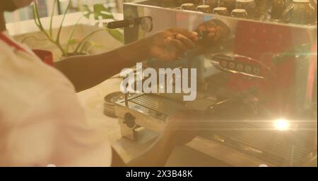 Image de la lueur de l'objectif et de la lumière du soleil avec les mains du barista préparant le café à l'aide de la machine Banque D'Images