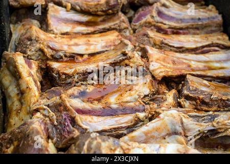 Beaucoup de côtes courtes de bœuf assaisonnées et marinées côte à côte, préparation pour un grand barbecue, foyer sélectionné, profondeur de champ étroite Banque D'Images