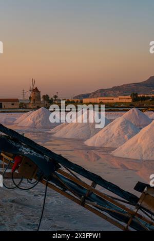 Vieux moulin à vent à Saline di Trapani e Paceco au coucher du soleil, Sicile. Banque D'Images