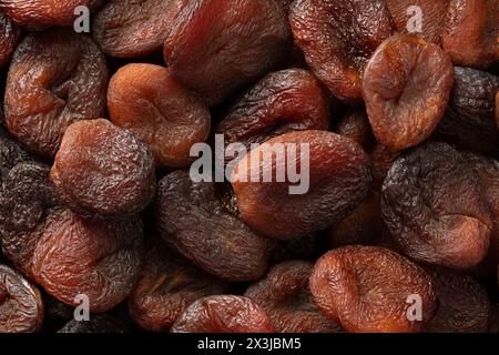 Naturel non sulfuré séché au soleil brun fruits d'abricots turcs Fermer plein cadre comme arrière-plan Banque D'Images