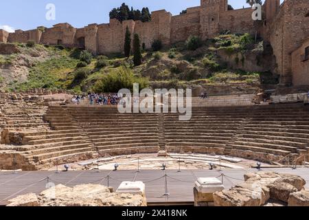 Touristes assis dans un ancien théâtre romain à Malaga par une chaude journée de printemps Banque D'Images