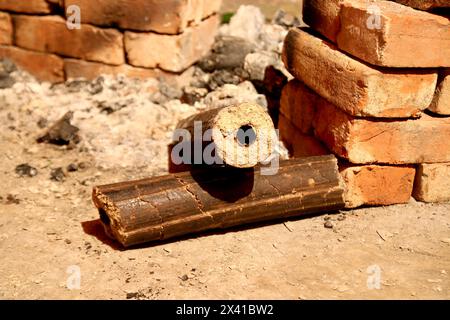 Charbons de bois, combustible solide renouvelable fabriqué à partir de la balle de riz. Cuisiner dans une fête de village sur un four temporaire en briques avec du combustible de briquette Rice Husk. Agro-RES Banque D'Images