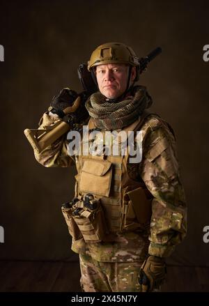 portrait d'un soldat airsoft avec des vêtements de camouflage et un fusil avec une lunette télescopique Banque D'Images