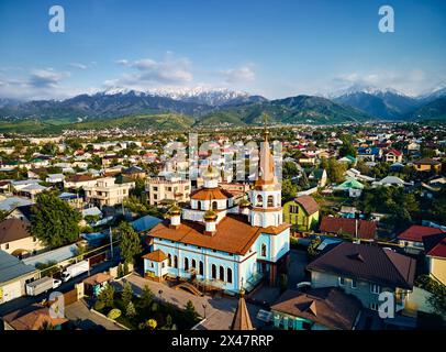 Drone aérien vue de haut en bas de la cathédrale église orthodoxe russe avec fond de montagne de neige dans la ville d'Almaty, Kazakhstan Banque D'Images