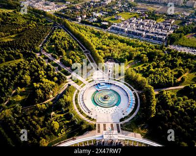 Vue aérienne par drone de l'arc d'entrée du parc du premier président à Almaty, Kazakhstan. Fontaine en forme de cercle au carré avec arc haut vers le bas plan. Banque D'Images